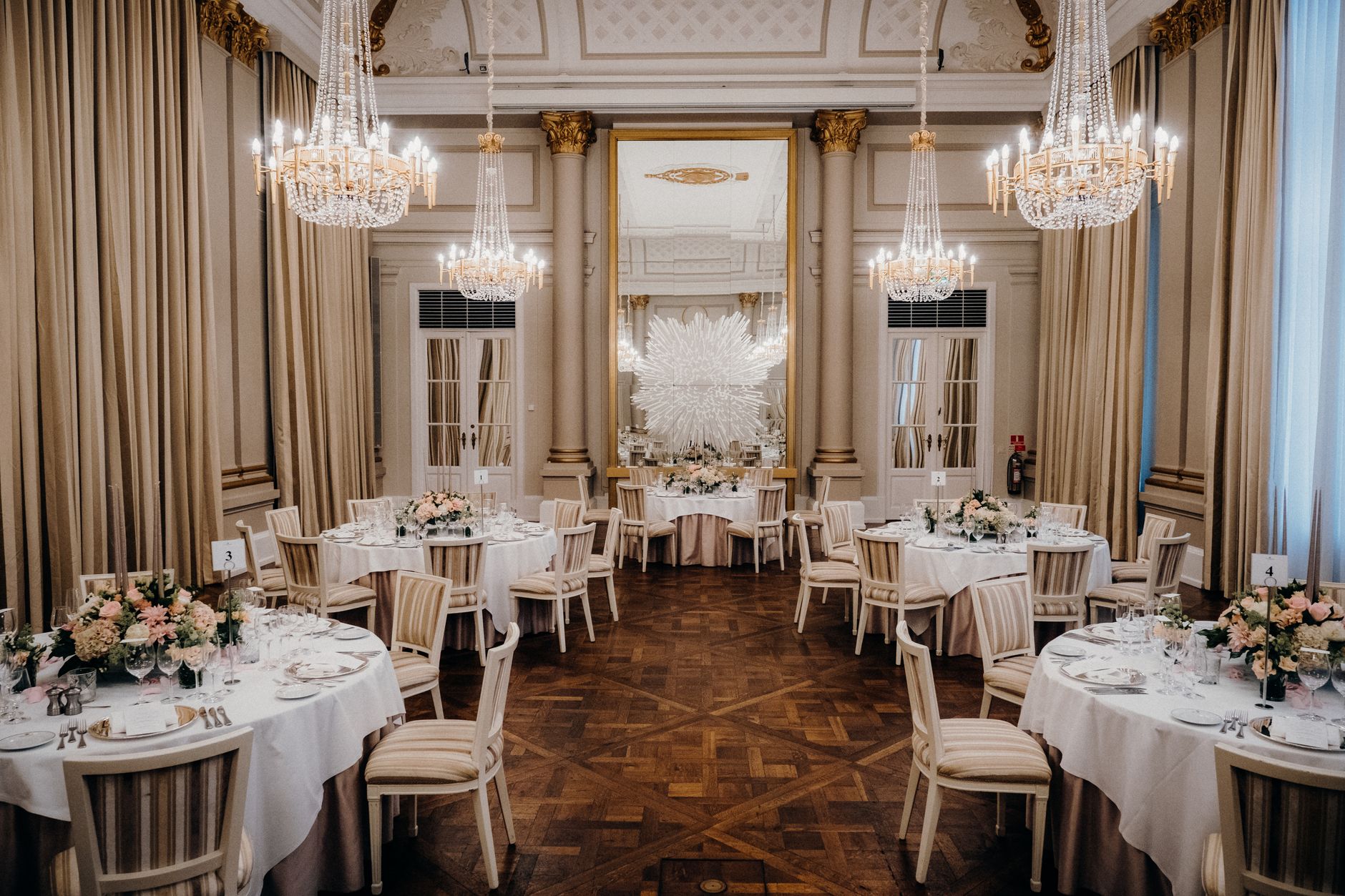 A grand wedding reception ballroom set for guests